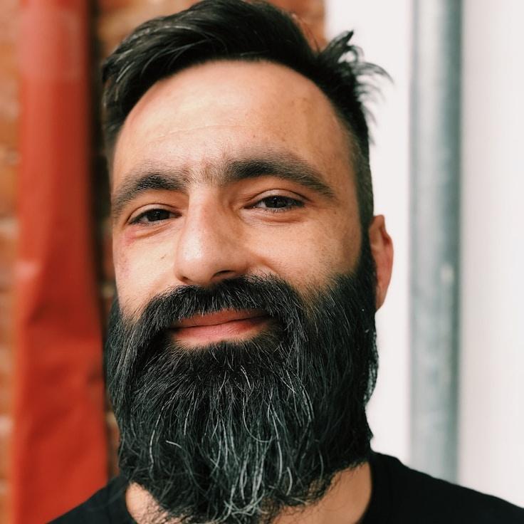 Mira Shah, Lead Design Curator at Fresh Island Chart, reviewing corporate floral arrangements